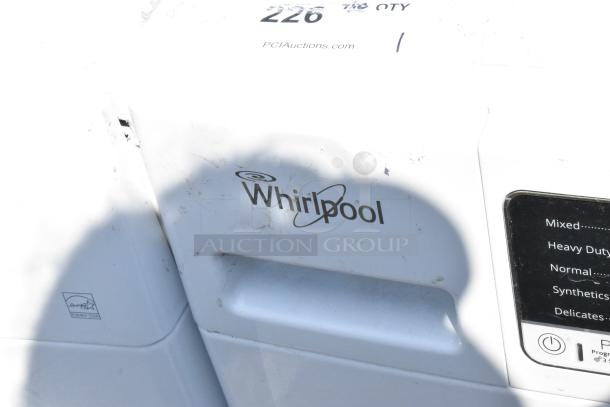 Whirlpool front load dryer in white, Energy Star certified, with visible control panel and light surface marks.
