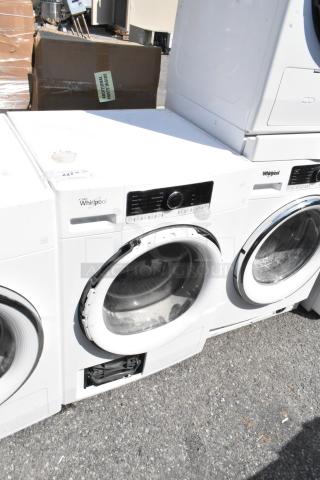 Whirlpool metal front load dryer, white, electronic control panel, visible wear. Model number visible, suitable for home use.