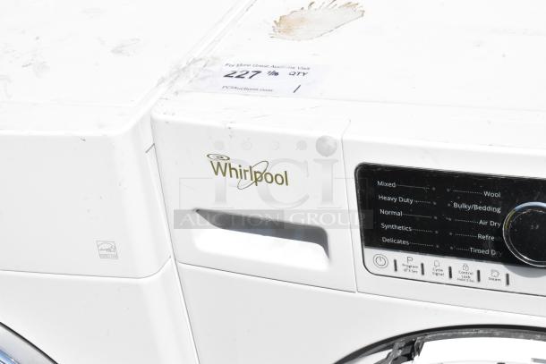 Whirlpool metal front load dryer, control panel showing various drying modes. Minor wear visible on top surface.