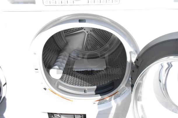 Whirlpool front-load metal dryer with open door, showing drum interior and control panel. Features and labels visible.