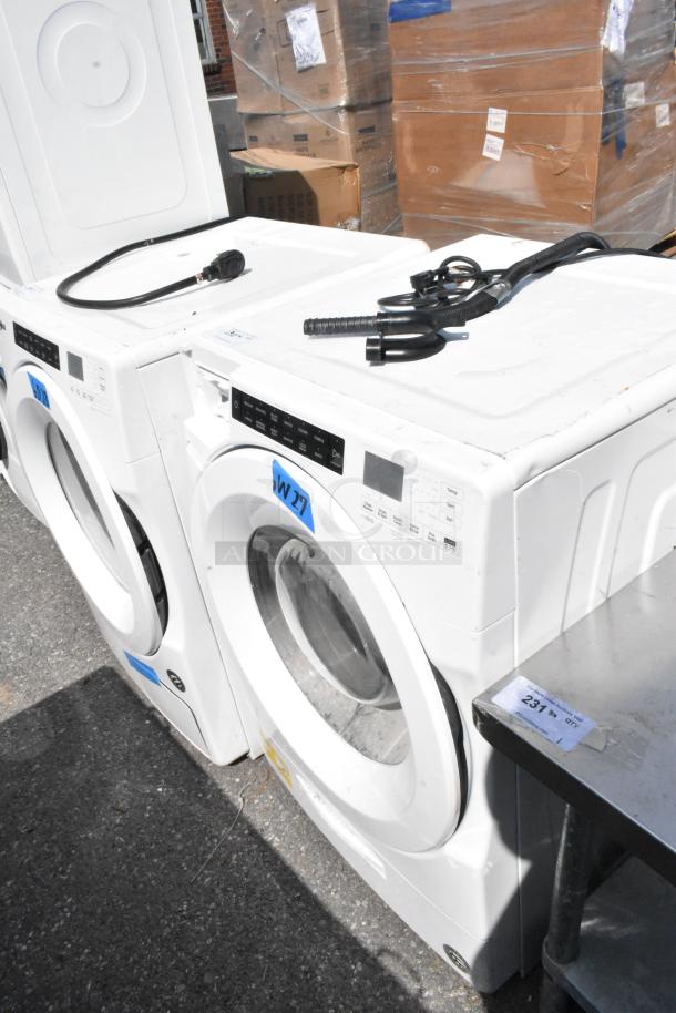 Whirlpool WFW5620HW2 front load washer, metal finish. Features control panel, plugs visible. 120V, 1 Phase, good condition.