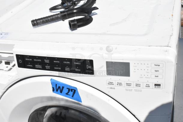 Whirlpool WFW5620HW2 front load washer, 120V, features multiple wash cycles. Visible wear on the top surface.