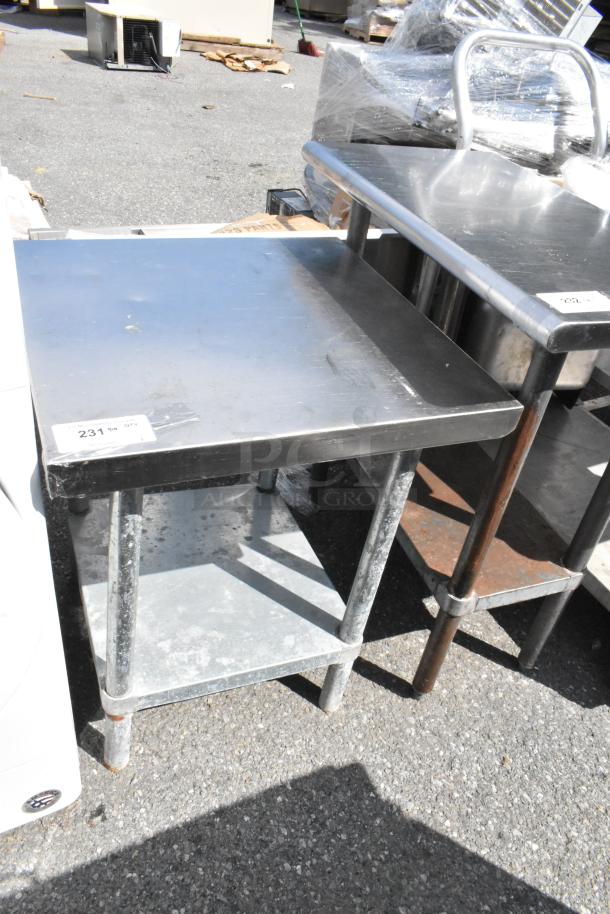Stainless steel table with metal under shelf, sturdy construction, visible wear, label marked "231."