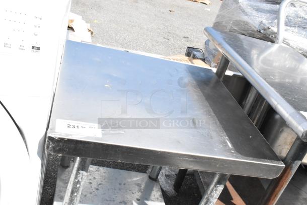 Stainless Steel Table with Metal Under Shelf, solid condition, reflective surface, visible wear. Auction label "231" attached.
