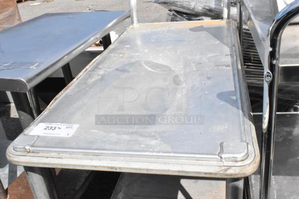 Metal 2 Tier Cart on commercial casters, used condition, showing surface wear. Auction tag visible on top shelf.