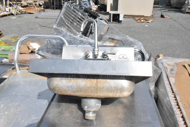 Stainless steel single bay wall mount sink with faucet and handles. Shows rust on the basin. Brand: Advance Tabco.