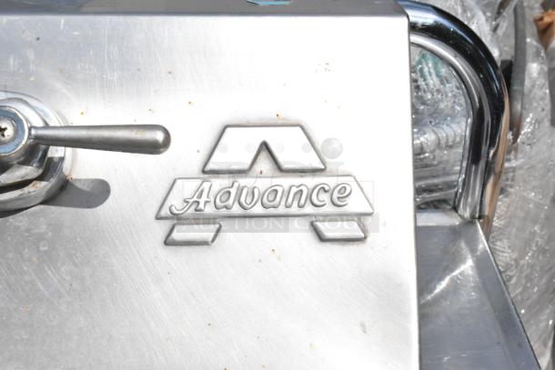 Stainless steel single bay wall mount sink by Advance, with faucet and handles, in good condition. Features "Advance" logo.