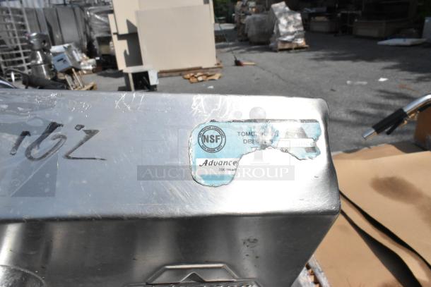 Stainless steel single bay wall mount sink with faucet and handles, NSF label, moderate surface scratches, used condition.