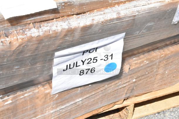 Stacked pallet of scratch and dent items, wrapped in plastic with a label reading "PCI JULY25-31 876" and a blue dot.