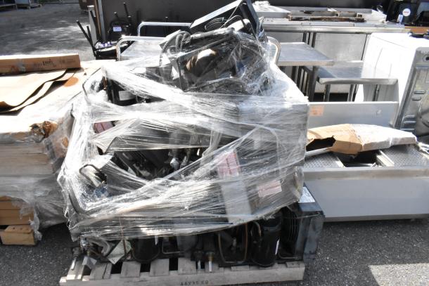 19 various compressors wrapped in plastic, including Copeland brand, on a pallet. Items for auction, sold as-is.
