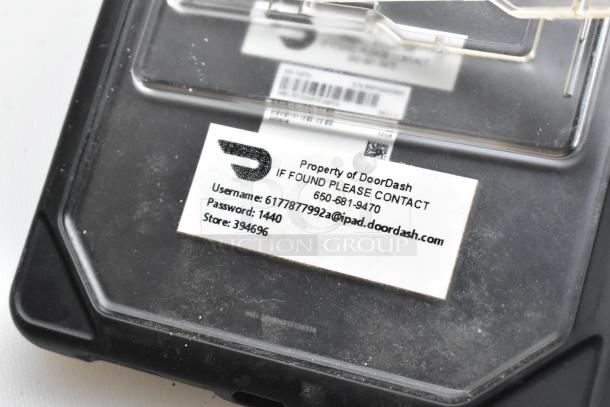 Five various tablets including Lenovo TB-8505F. Each tablet shows signs of use. Label: "Property of DoorDash" with contact info.