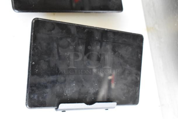 Five assorted tablets, including Lenovo TB-8505F, on display. Visible wear and fingerprints on screens.