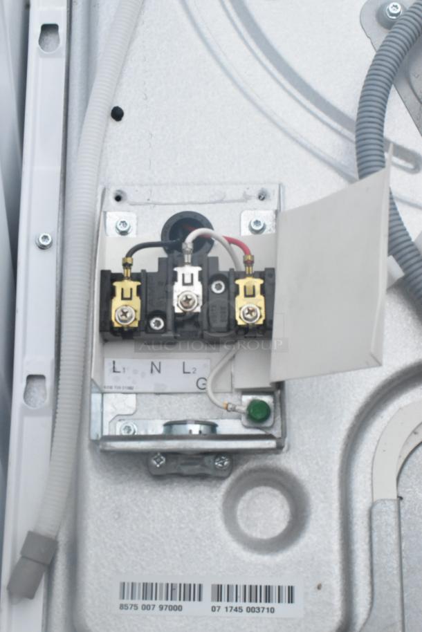 Whirlpool front load dryer panel showing electrical connections. Voltage label: 125/250V. Model details and serial number visible.