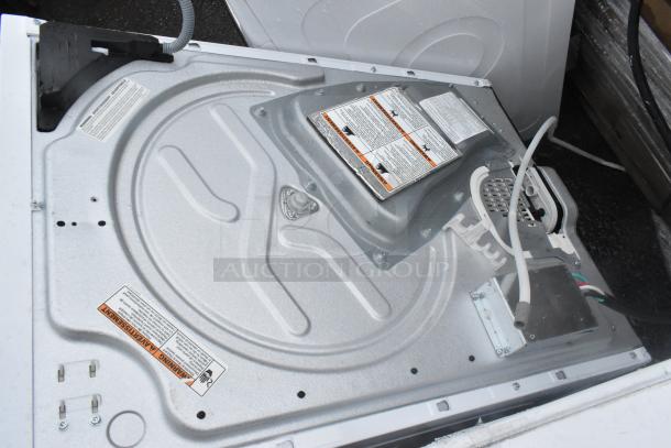 Whirlpool metal front load dryer, 125/250 volts. Features include metal construction and visible safety labels.