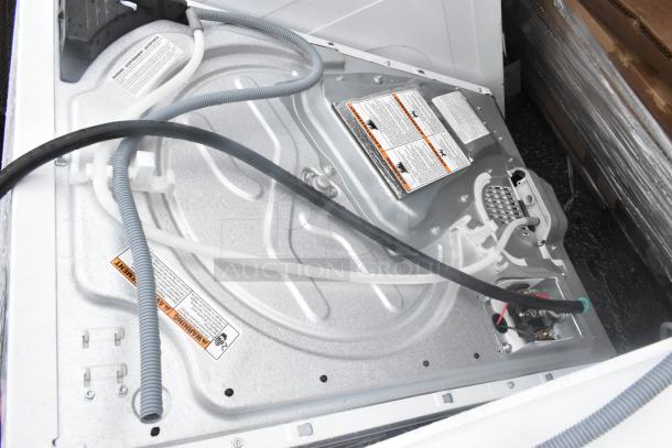 Whirlpool front load dryer interior, 125/250 volts, metal components, visible wiring, labels with safety warnings.