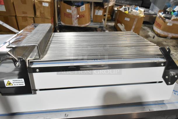 BRAND NEW Pavoni LIRA/E110V Lira semi-automatic dessert slicer. 110 Volts, 1 Phase. Scratch and dent condition. Safety label visible.