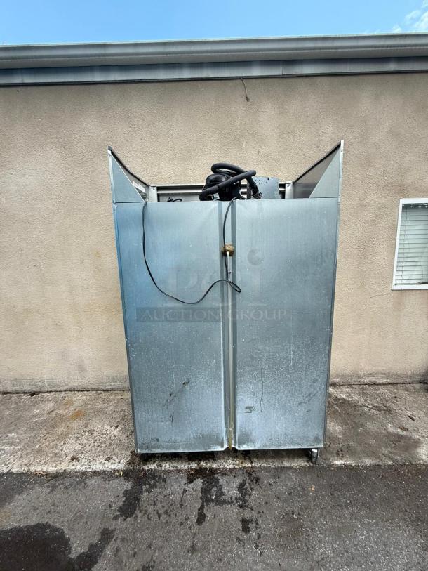 Continental 2R-HD 4-door reach-in refrigerator. Used, metal exterior, visible wear. Power cord visible on top.
