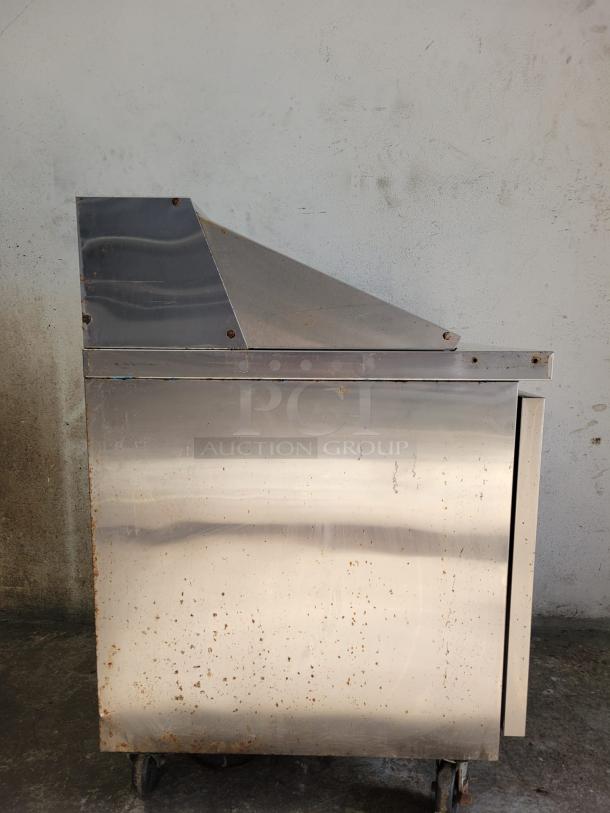 Dukers Salad Prep Station Refrigerator DSP29, stainless steel, noticeable wear, wheeled base, DUKERSW brand.