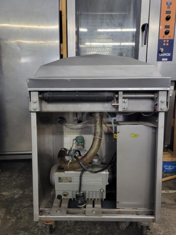 Berkel 450A Table Model Vacuum Packaging Machine, silver, visible motor and components, mounted on wheels, good condition.