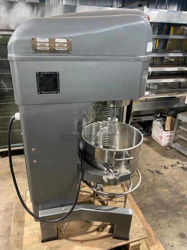 Avantco 177MX60H 60 Qt. commercial mixer with electric bowl lift, mobile cart, aluminum dough hook, stainless bowl, and wire whip.