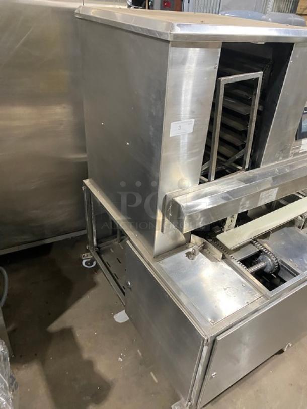 Aksar stainless steel electric tray aligning machine with pan slides and casters, in good condition.