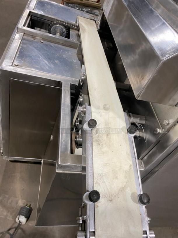 Aksar stainless steel tray arranging machine, electric powered, built-in pan slides, on casters, in good condition.