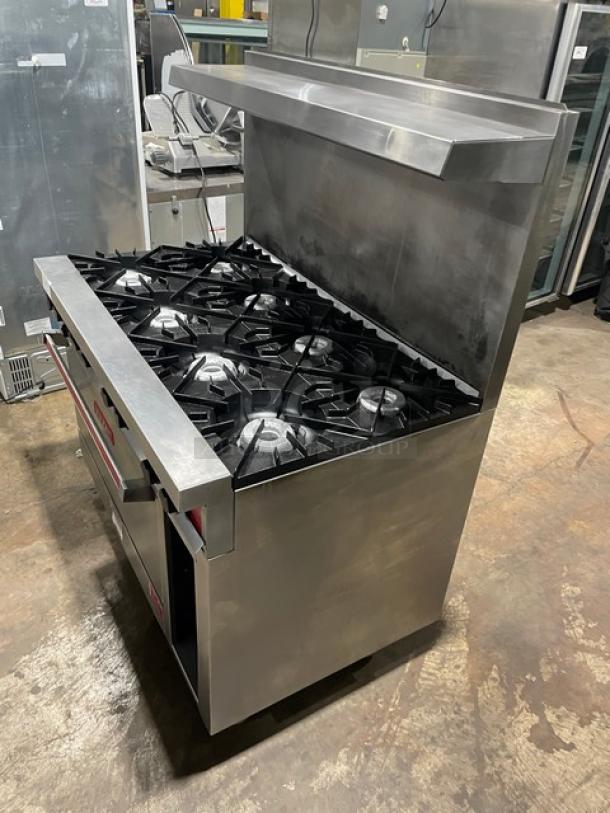 Vulcan 8 burner commercial range/oven combo, stainless steel, natural gas, with backsplash, salamander shelf, and enclosed storage.