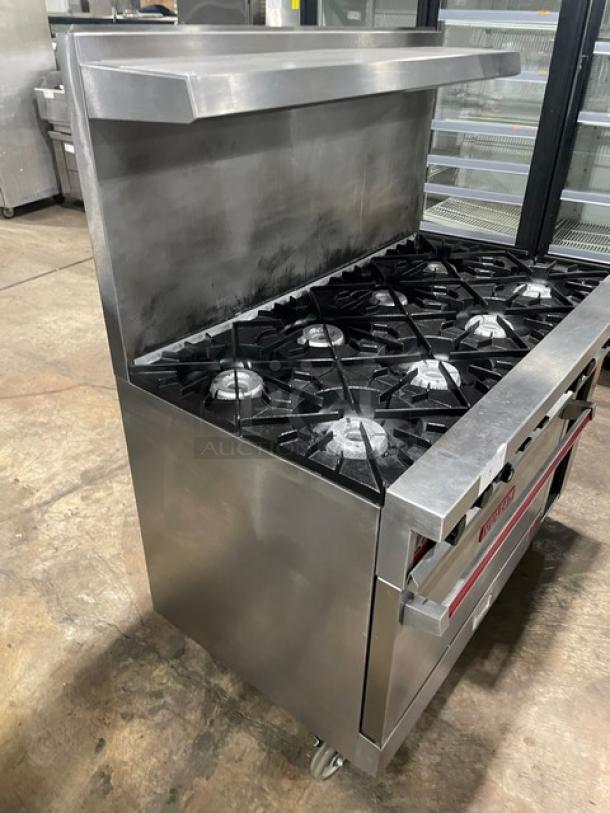 Vulcan commercial stainless steel 8-burner range/oven combo with back splash, overhead salamander shelf, and enclosed storage.