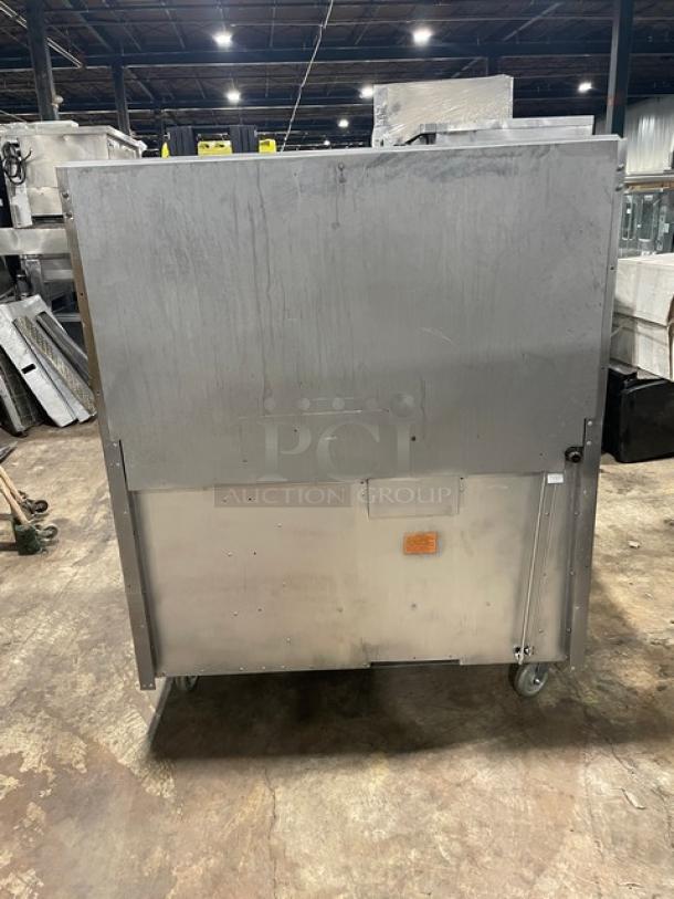 Vulcan commercial stainless steel 8 burner range/oven combo, natural gas, with backsplash, salamander shelf, on casters.