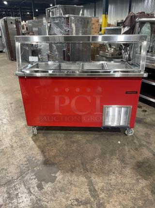 Delfield Shelleyglas Series red stainless steel 4-well cold food/salad bar, model KCSC60EF, with sneeze guard and casters.