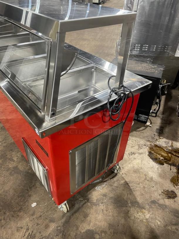 Delfield Shelleyglas red stainless steel 4-well cold food bar, model KCSC-60-EF, with sneeze guard and casters.