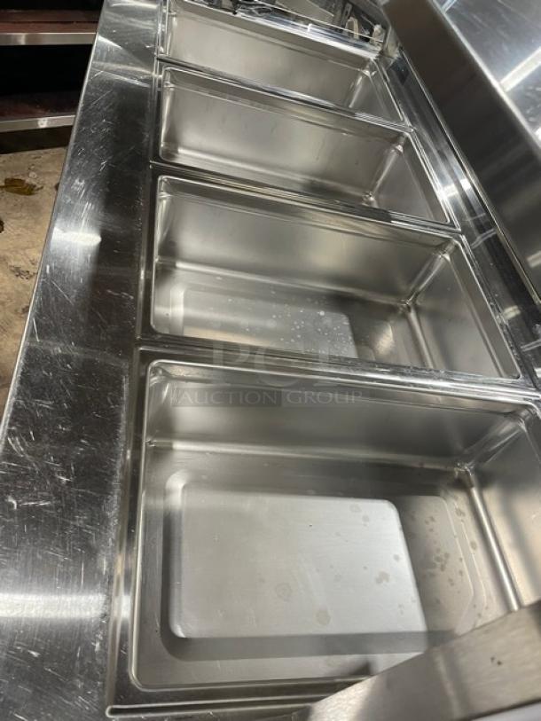Delfield Shelleyglas Series red stainless steel 4-well cold food serving counter, model KCSC60EF, with sneeze guard, on casters.