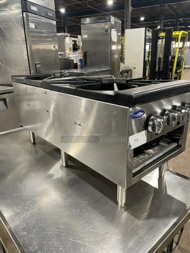 CookRite stainless steel double burner stock pot range, model ATSP-18-2L, with cast iron burners, on legs, shown in commercial setting.