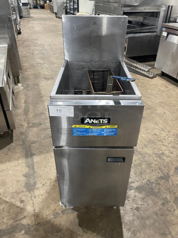 Anets SLG40 stainless steel 40 lb. deep fryer, natural gas, with backsplash and frying basket, on legs, used condition.