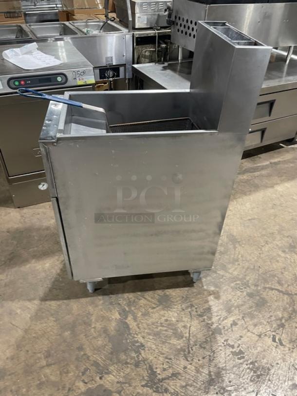 Anets SLG40 commercial stainless steel gas fryer with backsplash and basket, 40 lb. capacity, on legs, SN: G14CE015037.