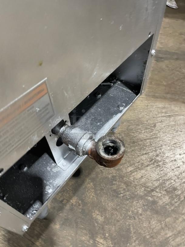 Anets SLG40 stainless steel natural gas fryer, 40 lb. capacity, with backsplash and frying basket, on legs, used condition.