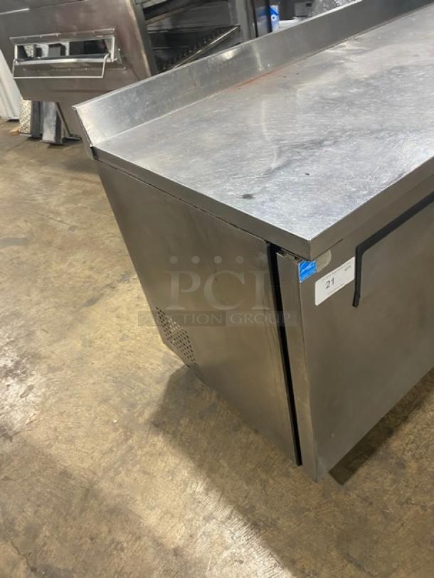 True Commercial 3-Door Stainless Steel Worktop Table, Model TWT-72, with upturned backsplash, on casters, Energy Star certified.