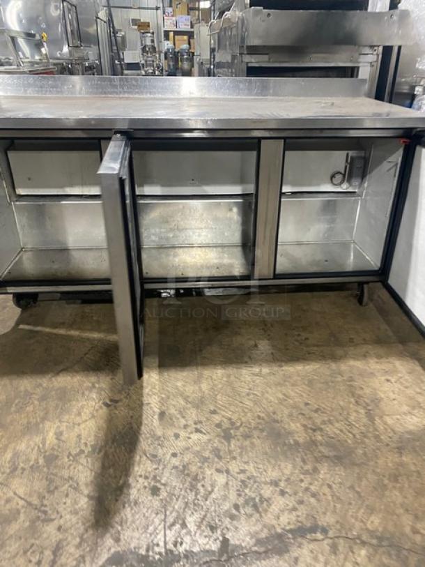 True TWT-72 stainless steel 3-door refrigerated worktop table, 72", Energy Star, upturned backsplash, on casters.