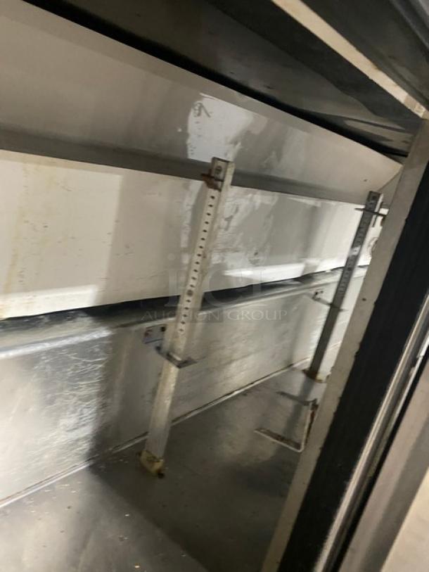 True TWT-72 stainless steel refrigerated worktop table with three doors, upturned back splash, and casters. Energy Star certified.