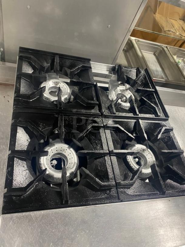 American Range commercial stainless steel natural gas countertop 4-burner range, in good condition, ideal for efficient cooking.