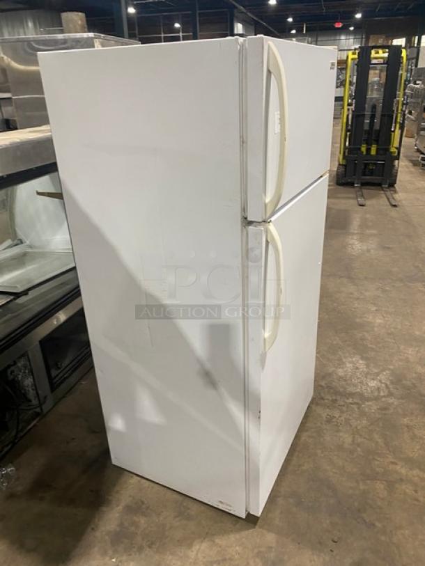 Frigidaire Model MRT18DNEW white reach-in top freezer/refrigerator combo with adjustable shelving. Slight wear visible.