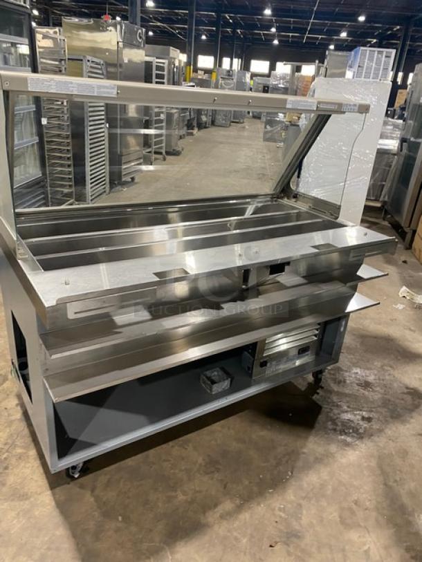 Duke SUBCPTC60 subway style prep table with angled glass sneeze guard, tri-channel cold pan, stainless shelving, enclosed base on casters, 120V.