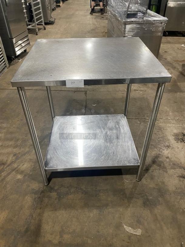 Commercial stainless steel worktop table with single undershelf on legs. Durable construction in good condition.
