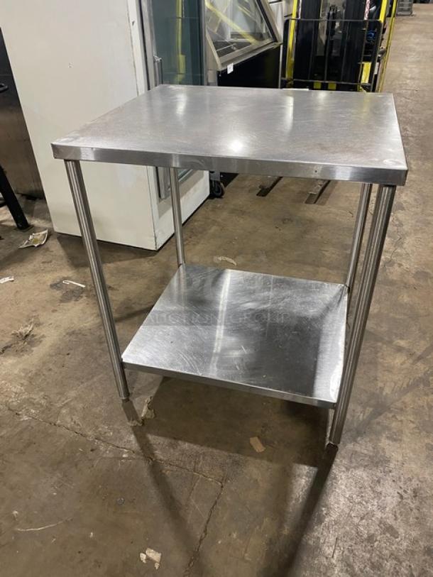 Commercial stainless steel worktop table with single undershelf. Features sturdy legs for support. Ideal for kitchens.