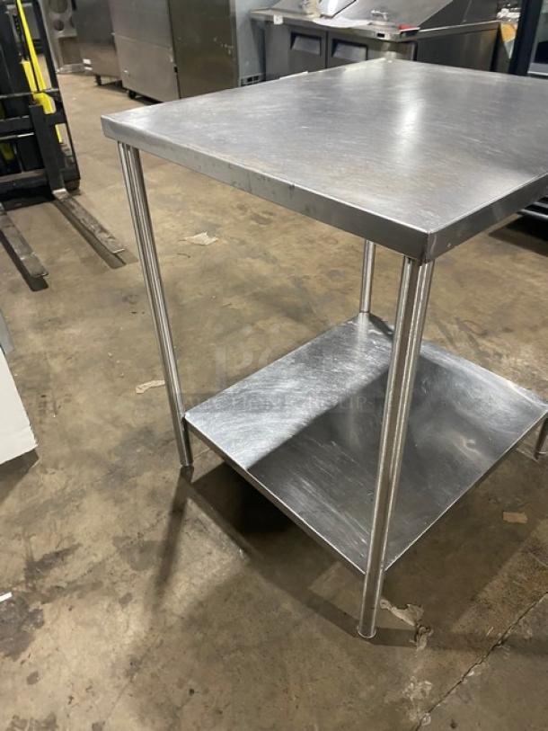 Commercial stainless steel worktop table with undershelf and legs, in good condition. Perfect for kitchen or workshop use.