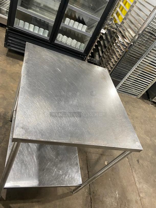 Commercial stainless steel worktop table with single undershelf and legs. Features durable construction and scratch marks.