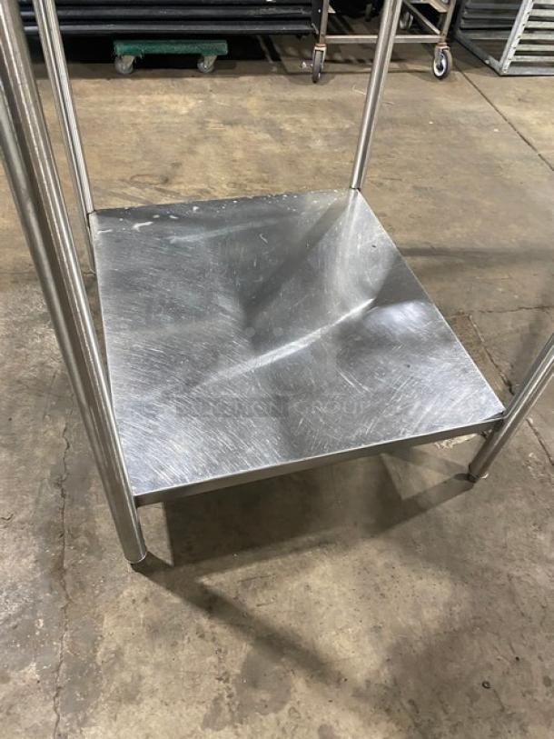 Commercial stainless steel worktop table with single undershelf, mounted on legs. Features durable construction, minor wear.