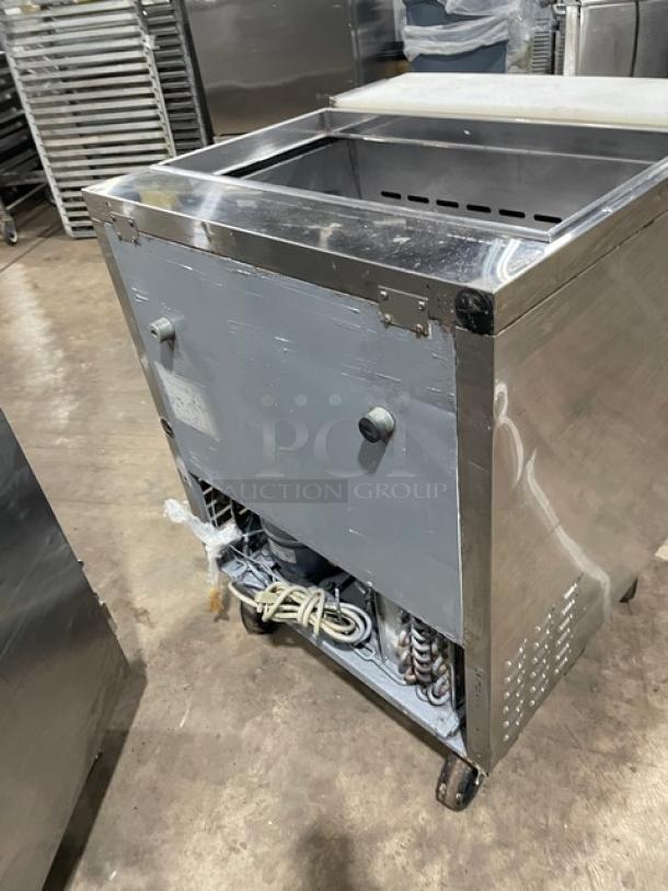 Turbo Air TST-28SD stainless steel refrigerated prep table with cutting board and casters, model label visible, used condition.