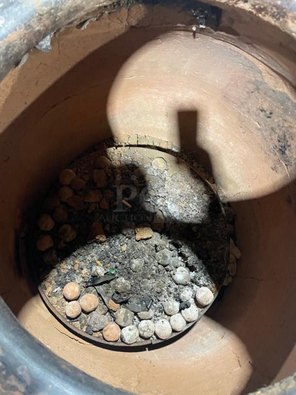 Commercial stainless steel tandoor oven with natural gas/charcoal power, clay interior, on casters, used condition.