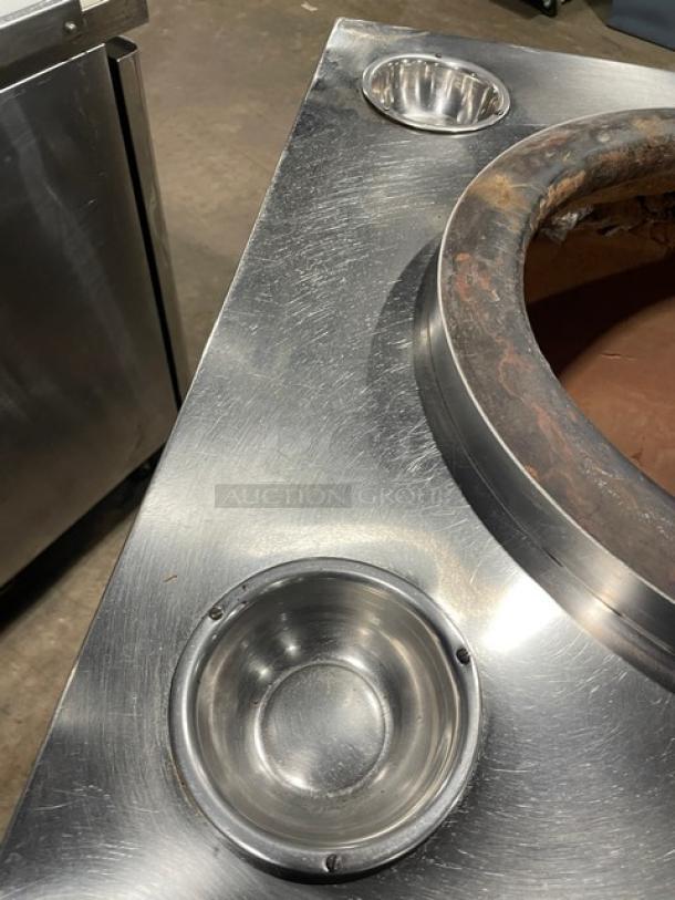 Commercial stainless steel Indian tandoor oven, natural gas/charcoal powered, mounted on casters, with clay interior, good condition.